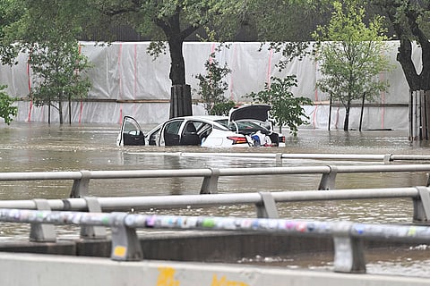 A vehicle is stranded on flooded Allen Parkway